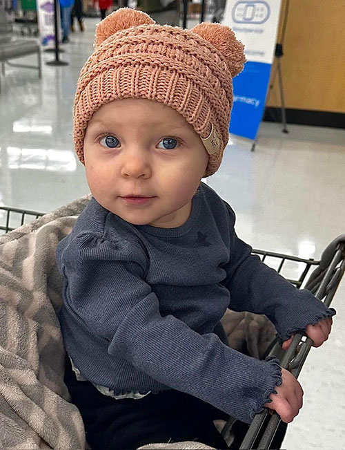 Emberlyn looking at the camera while at the grocery store.