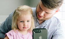 Girl and her father consulting with a physician via the smartphone app