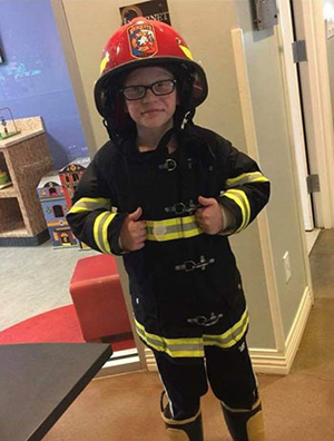 Aidan dressed as a fire fighter