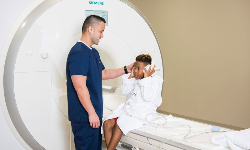 MRI tech prepping little boy for MRI