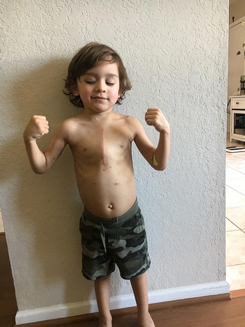 Little boy flexing his muscles.