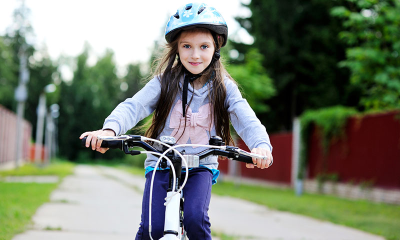 girl with helmet on bike
