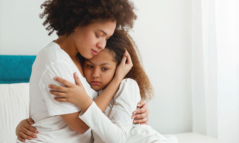 Mother comforting daughter