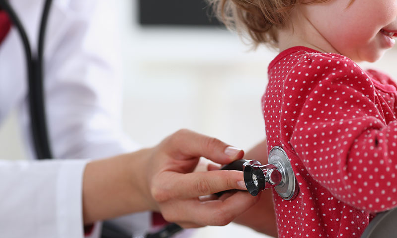 Physician checking out little girl