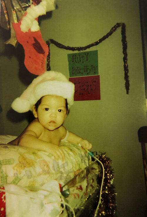 Baby picture of Jade wearing a Christmas hat.