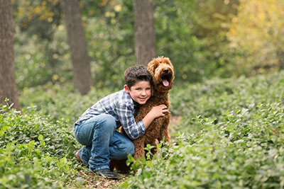 Easton and his dog in a field