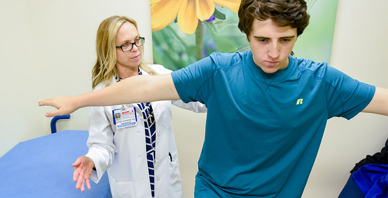 Doctor and teenage boy patient in a concussion exam