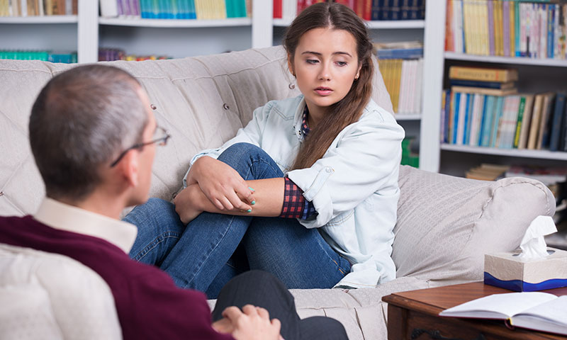 teenage girl on couch during therapy session