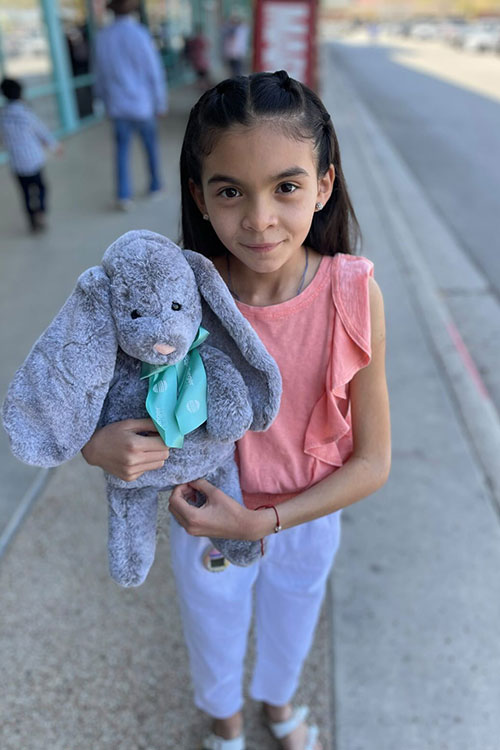 Little girl holding stuffed animal