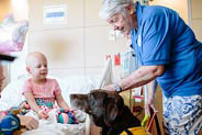 pet therapy volunteer visits patient in her room