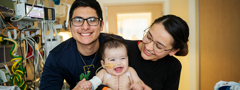 Miles with mom and dad laughing after having a heart transplant only 10 days earlier. Miles is the 300th heart transplant to have been performed at Children's Medical Center Dallas.