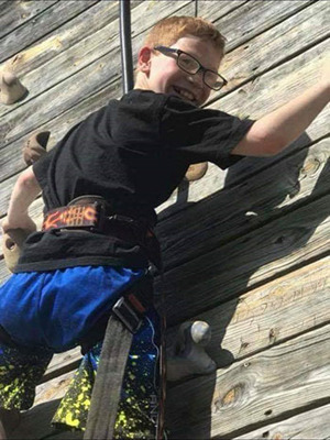 Aidan on rock climbing wall
