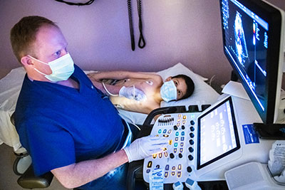 Sonographer conducts an ECHO imaging procedure