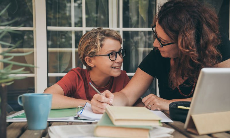 Child doing school work with mom
