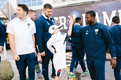 Henry with Notre Dame football players