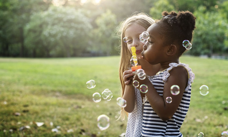 Little girls blowing bubbles