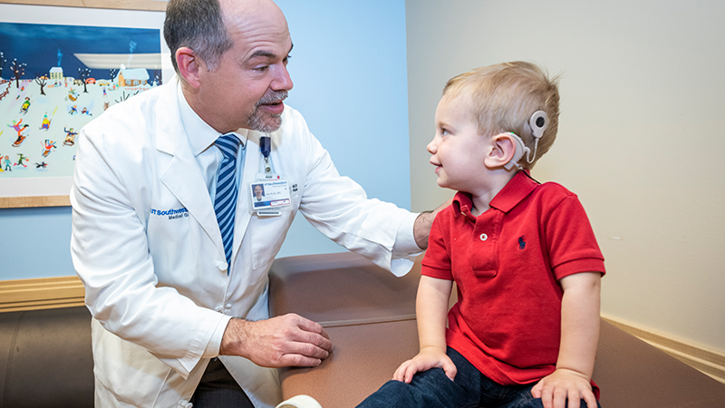 Dr. Kutz is with patient Brody in the ENT Cochlear Implant Clinic at Children's Health.