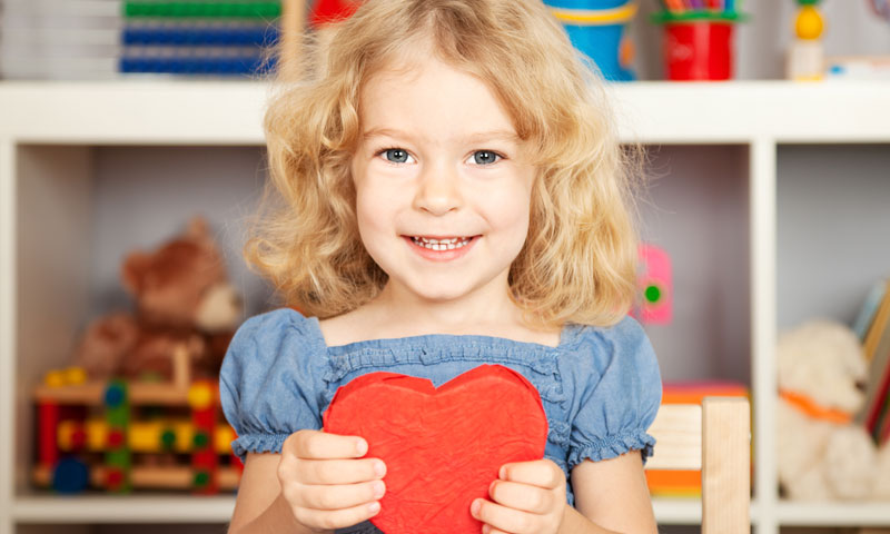 Little girl holding valentine heart