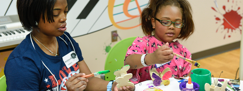 Ashlyn and her mom are having fun in the therapeutic arts room at Children's Health.