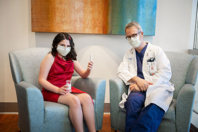 Ava wearing a mask while posing for a picture with the doctor