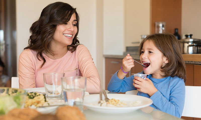mother and daughter eating healthy meal together