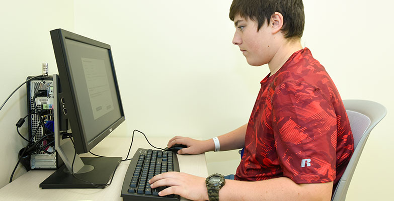 teenage boy using a computer