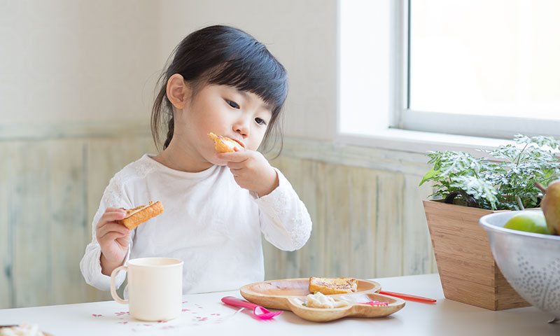 little girl eating bread