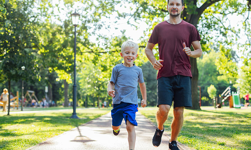 Father and son running in the park