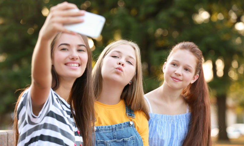 Three young girls taking a selfie together