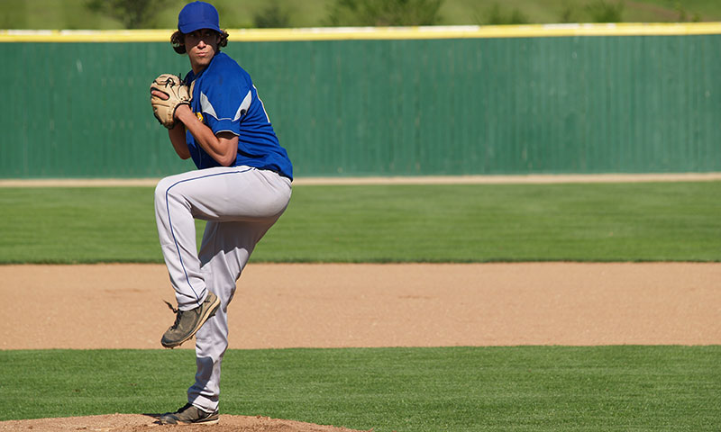 baseball player winding up for a pitch