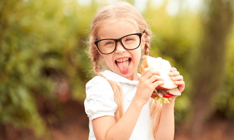 Little girl with sandwich